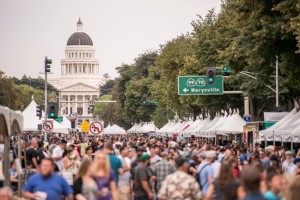 an image of last years Brewfest with hundreds of people on the Capitol Mall in Sacramento with the Capital building in the background