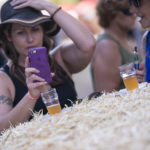 woman taking picture of beer